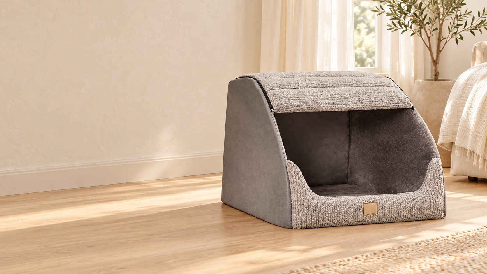 Gray covered pet bed beside a cream sofa