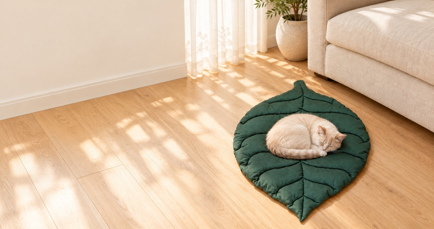 Cream cat resting on a dark green leaf shaped pet mat